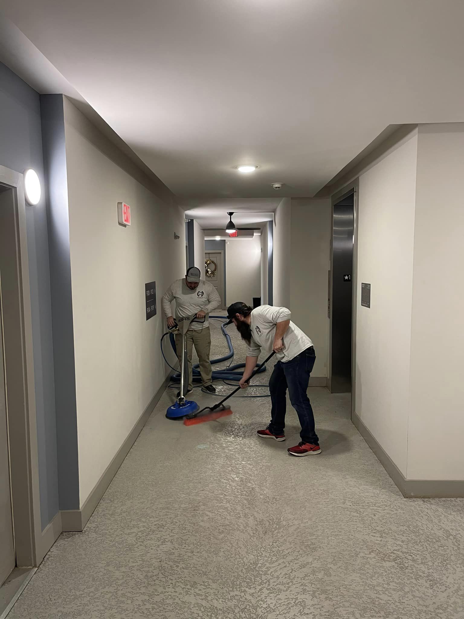 a group of men cleaning a hallway